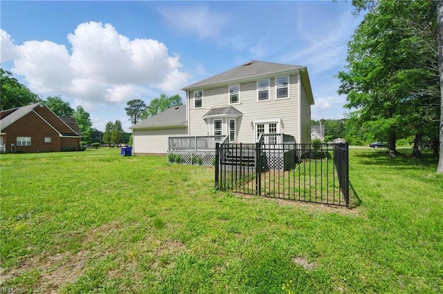 back of property with a lawn and a deck
