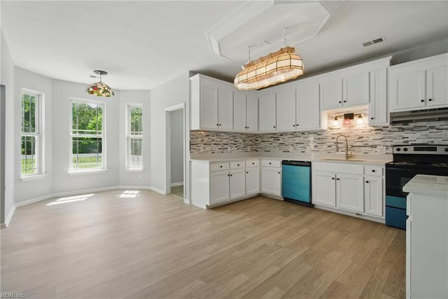 kitchen featuring electric range, visible vents, a sink, dishwashing machine, and under cabinet range hood
