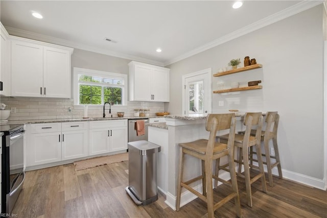 kitchen featuring backsplash, stainless steel appliances, light stone counters, and light wood-type flooring