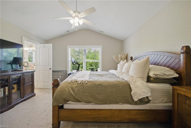 bedroom featuring a ceiling fan, light colored carpet, and vaulted ceiling