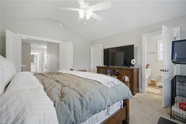 bedroom with a ceiling fan, lofted ceiling, ensuite bath, and light carpet
