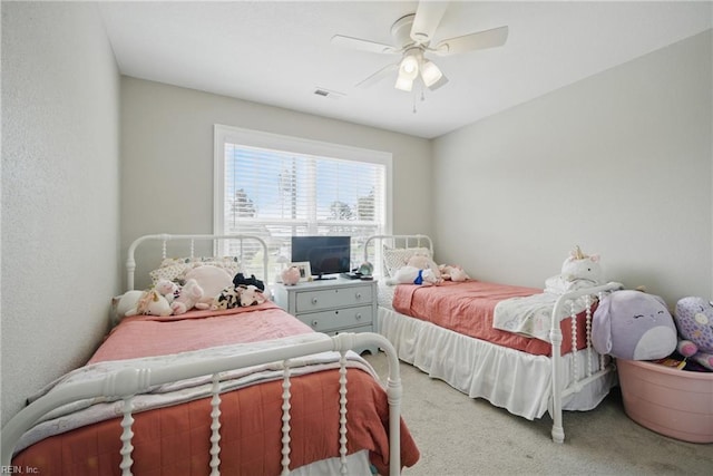 bedroom featuring ceiling fan, visible vents, and light carpet