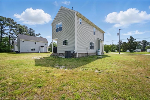 view of property exterior with a yard and central AC
