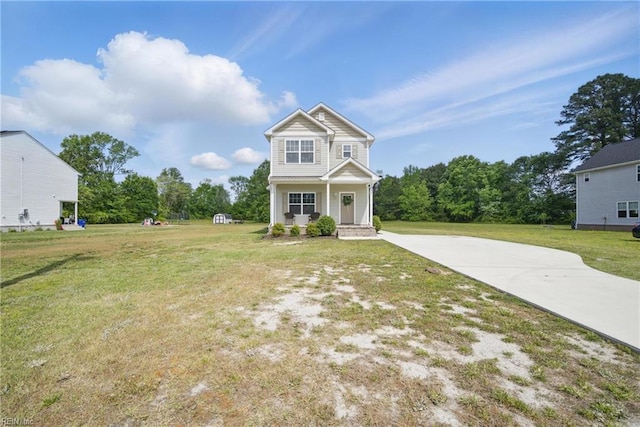 view of front facade with covered porch, driveway, and a front yard