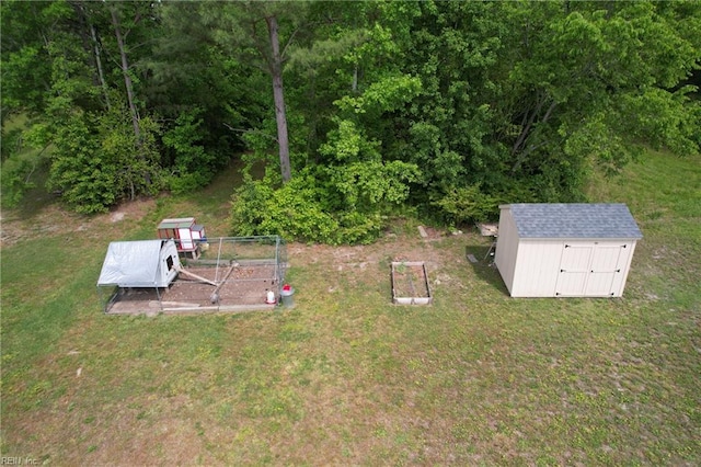 view of yard with a storage shed and an outbuilding