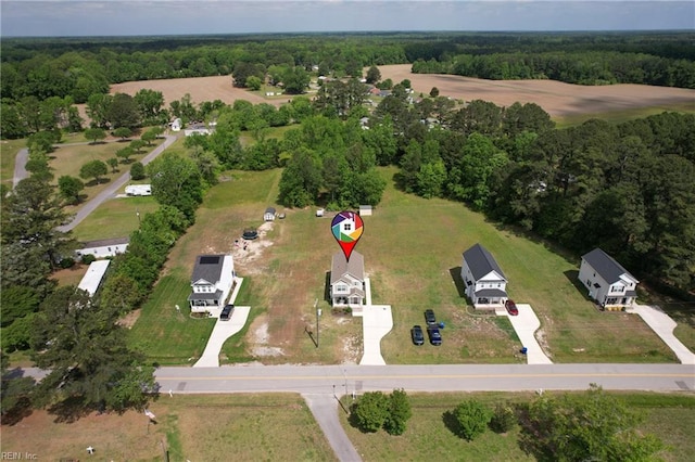 drone / aerial view with a wooded view