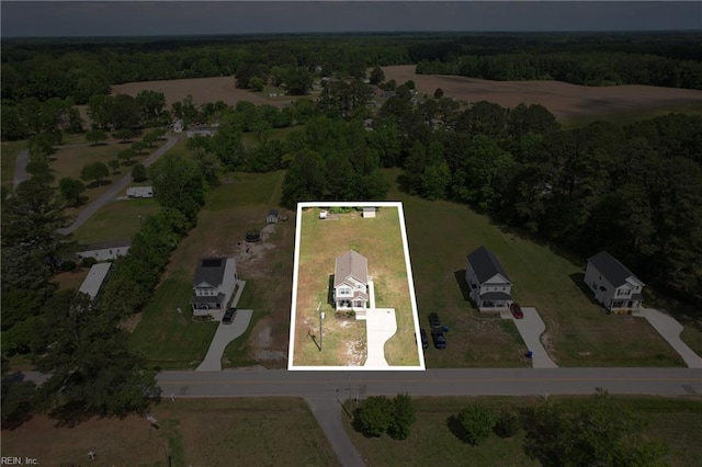 birds eye view of property featuring a view of trees