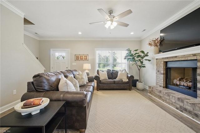 living room with recessed lighting, crown molding, a brick fireplace, and ceiling fan