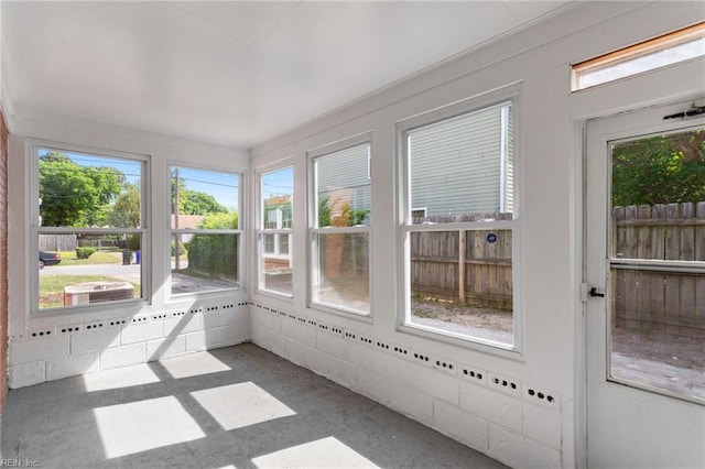 unfurnished sunroom featuring a healthy amount of sunlight