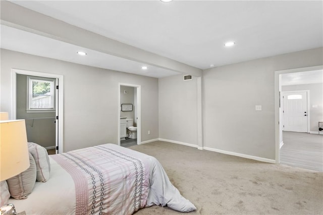 carpeted bedroom featuring recessed lighting, baseboards, ensuite bathroom, and visible vents