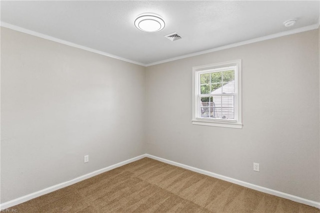 carpeted empty room featuring baseboards, visible vents, and ornamental molding