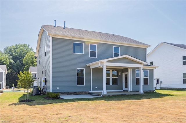 back of property with a lawn, cooling unit, and a porch