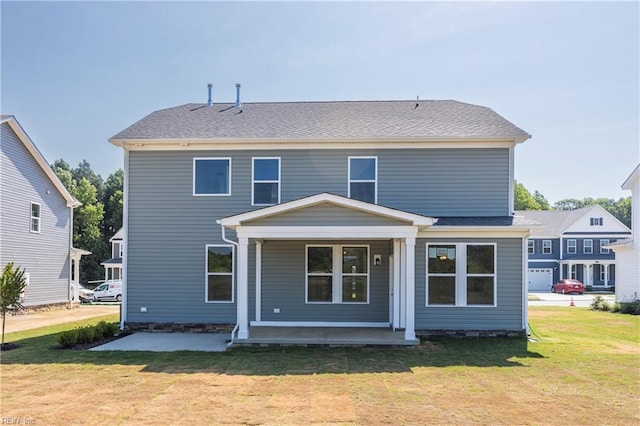 back of property with a lawn and covered porch