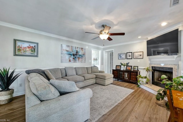 732 Mandarin Ln, Chesapeake, VA 23323 - living area with crown molding, a fireplace with raised hearth, wood finished floors, and visible vents