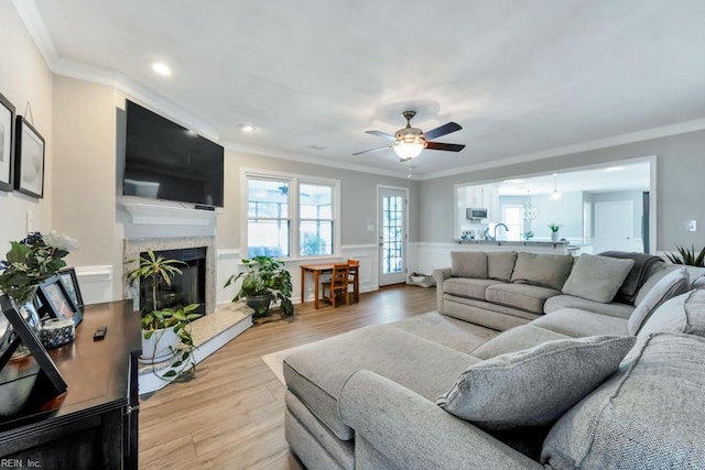 732 Mandarin Ln, Chesapeake, VA 23323 - living area with crown molding, ceiling fan, a fireplace, and wainscoting