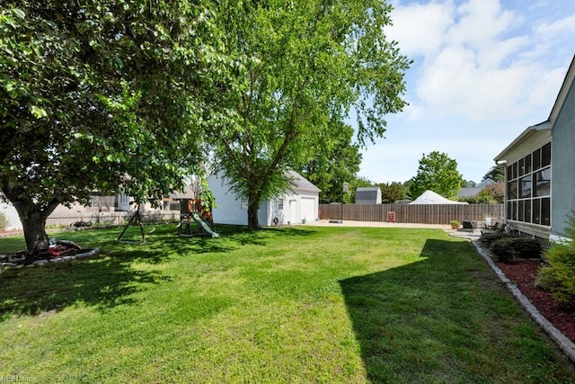732 Mandarin Ln, Chesapeake, VA 23323 - view of yard featuring a playground, an outdoor structure, and a fenced backyard