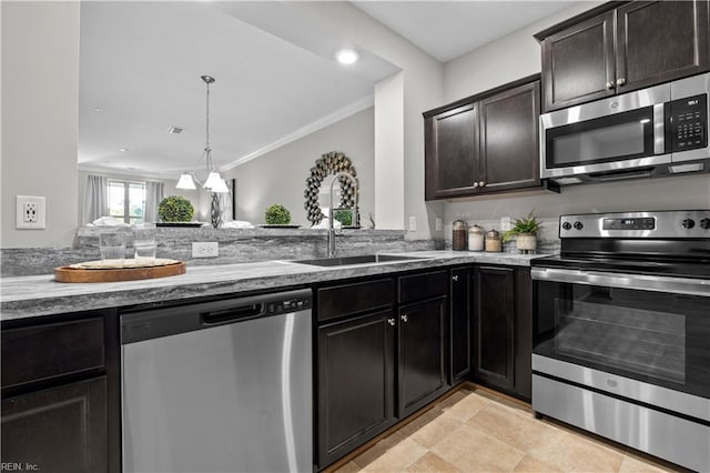 kitchen with crown molding, appliances with stainless steel finishes, a sink, stone counters, and visible vents