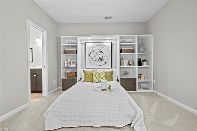bedroom featuring baseboards, ensuite bathroom, carpet flooring, and visible vents