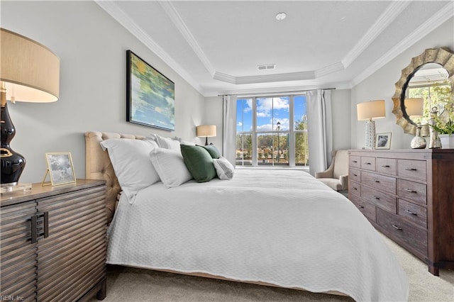 bedroom with visible vents, a raised ceiling, carpet, and crown molding