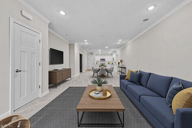 living area with recessed lighting, baseboards, and ornamental molding