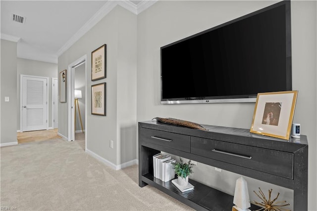 corridor with visible vents, baseboards, crown molding, and light colored carpet