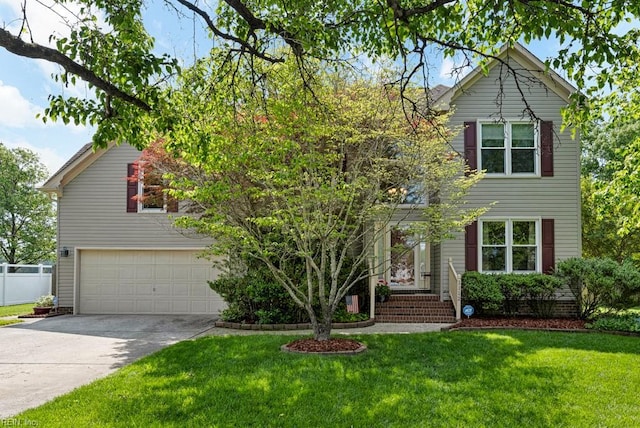 view of front of property with concrete driveway, fence, and a front lawn