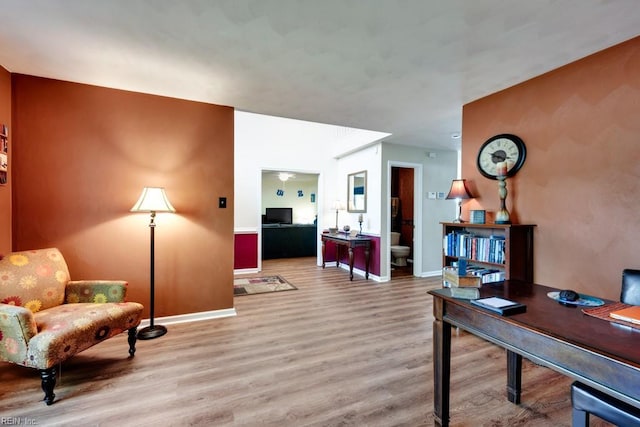interior space with baseboards and wood finished floors
