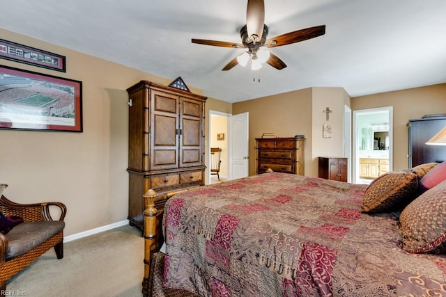 bedroom with baseboards, carpet flooring, ceiling fan, and ensuite bath