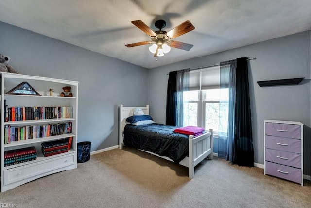 carpeted bedroom featuring baseboards and ceiling fan