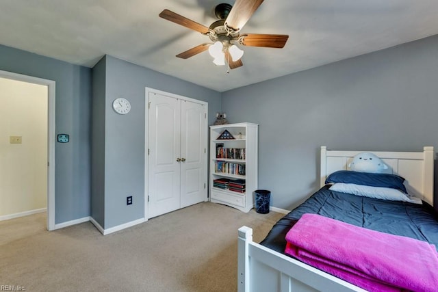 carpeted bedroom with baseboards, ceiling fan, and a closet