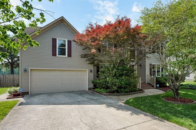 view of front of property featuring fence, an attached garage, driveway, and a front yard