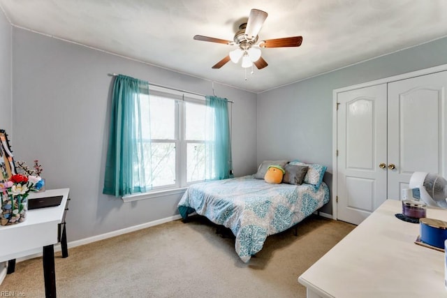 bedroom featuring baseboards, carpet, ceiling fan, and a closet