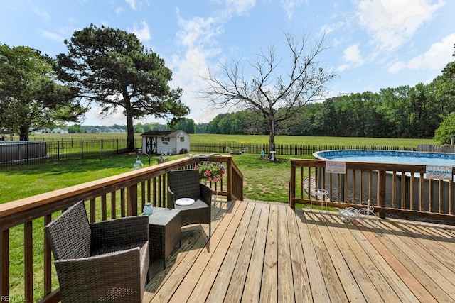 wooden deck featuring a lawn, a fenced backyard, and a fenced in pool