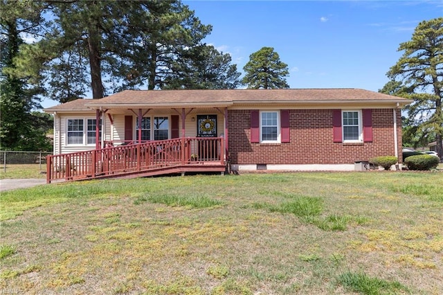 view of front facade with fence, covered porch, crawl space, and a front yard