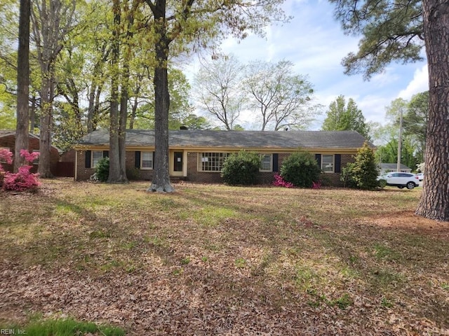 single story home featuring brick siding