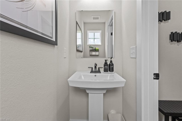 bathroom featuring a textured wall