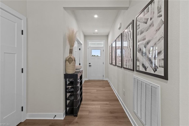 corridor with visible vents, recessed lighting, baseboards, and wood finished floors