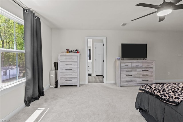 carpeted bedroom with visible vents, baseboards, and ceiling fan