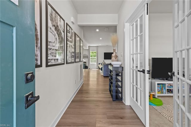 hall with recessed lighting, french doors, and wood finished floors