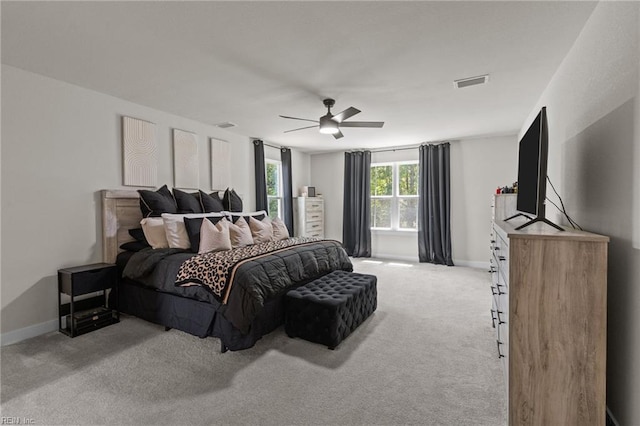bedroom with baseboards, carpet flooring, ceiling fan, and visible vents