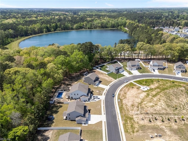 aerial view with a water view, a residential view, and a forest view