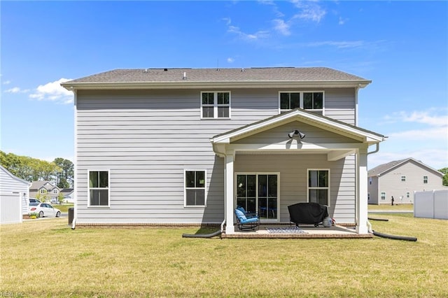 rear view of house with a yard and a patio area