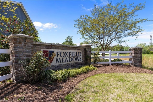 community sign featuring fence