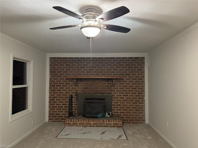 unfurnished living room featuring carpet floors, baseboards, a fireplace, and a ceiling fan