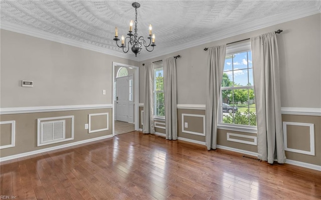 721 Greenwing Dr, Chesapeake, VA 23323 - unfurnished room featuring visible vents, baseboards, wood-type flooring, a chandelier, and ornamental molding