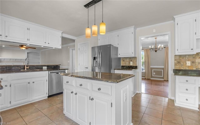 721 Greenwing Dr, Chesapeake, VA 23323 - kitchen with crown molding, a sink, ceiling fan with notable chandelier, stainless steel appliances, and light tile patterned flooring