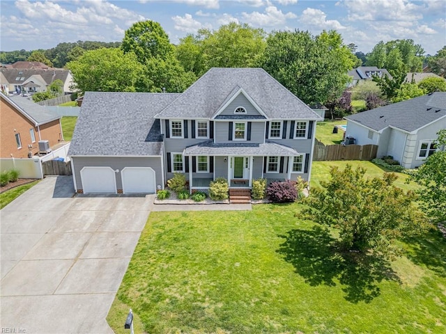 721 Greenwing Dr, Chesapeake, VA 23323 - colonial home with concrete driveway, an attached garage, fence, and a front lawn