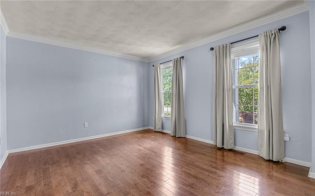721 Greenwing Dr, Chesapeake, VA 23323 - empty room featuring crown molding, baseboards, visible vents, and hardwood / wood-style flooring