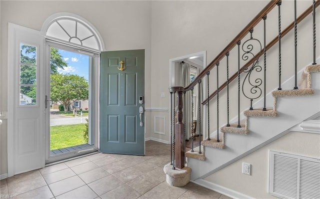 721 Greenwing Dr, Chesapeake, VA 23323 - foyer with visible vents, stairs, light tile patterned flooring, and a wealth of natural light