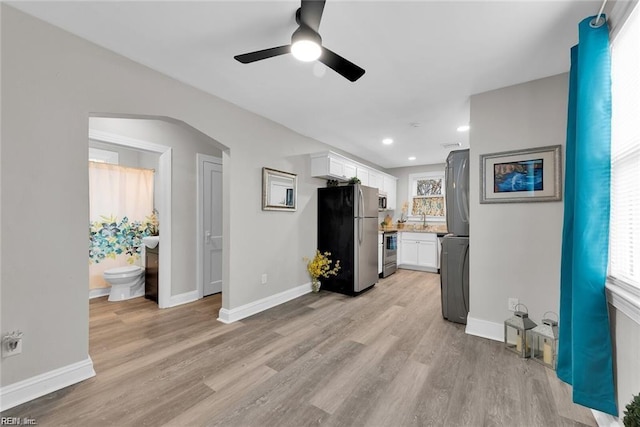 unfurnished living room with recessed lighting, baseboards, ceiling fan, and light wood-type flooring